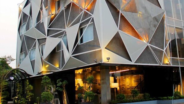 A modern building with a geometric facade and large windows.