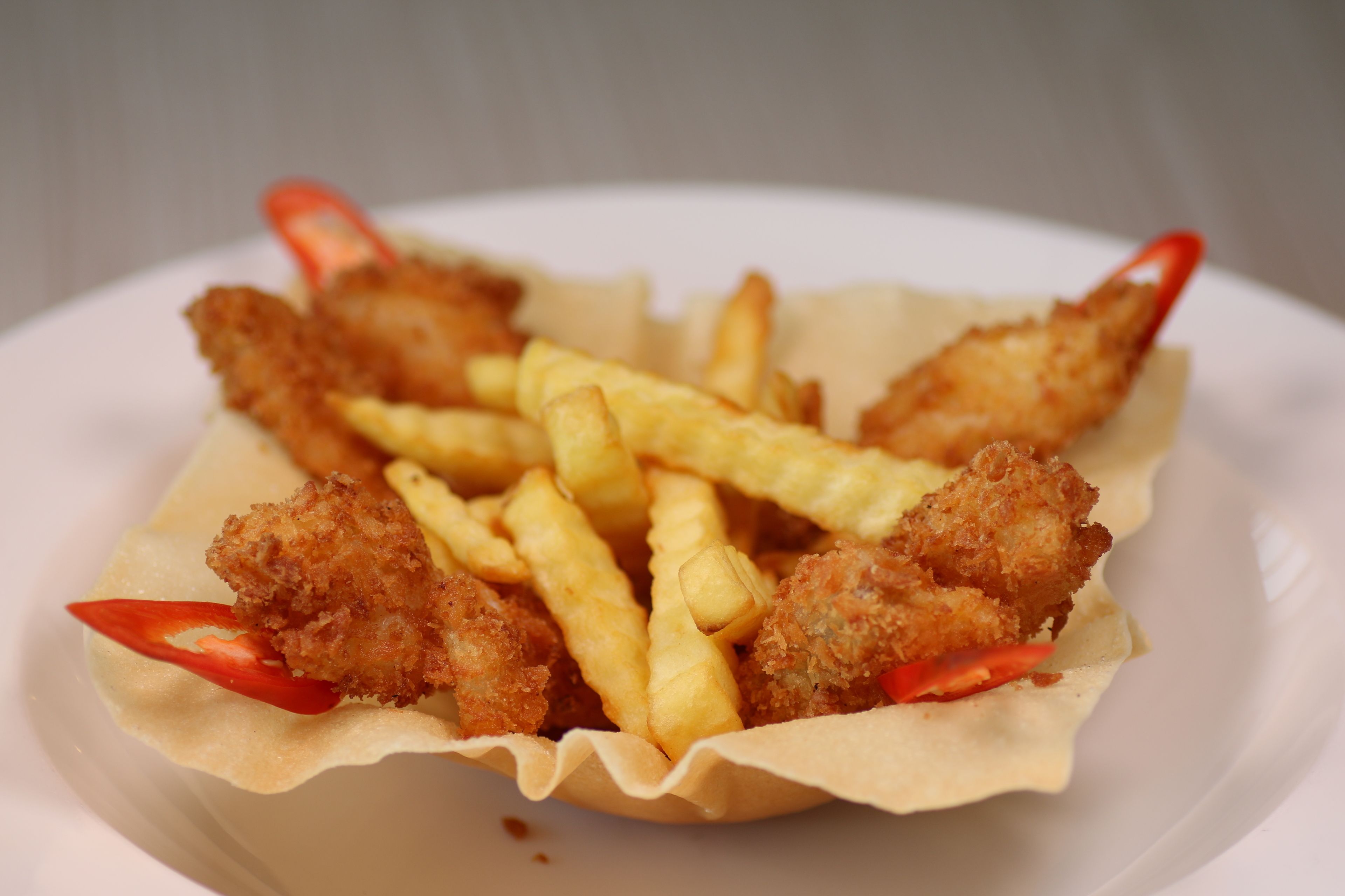 A plate of breaded chicken tenders and French fries.