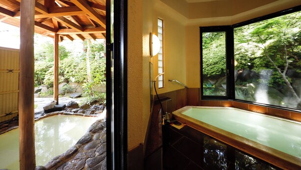 A bathroom with a stone sink, wooden ceiling beams, and a view of a garden through a large window. - Ryokan Kiritani Hakoneso (Hakone)