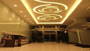 A modern lobby with a geometric ceiling design and a reception desk. - Sunee Grand Hotel (Ubon Ratchathani)