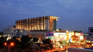 A multi-story hotel with a modern design, featuring a prominent 'S' on the facade.