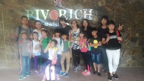 A group of people posing in front of a sign with the text "RIVORICH". - Rivorich Residence (Kandy)