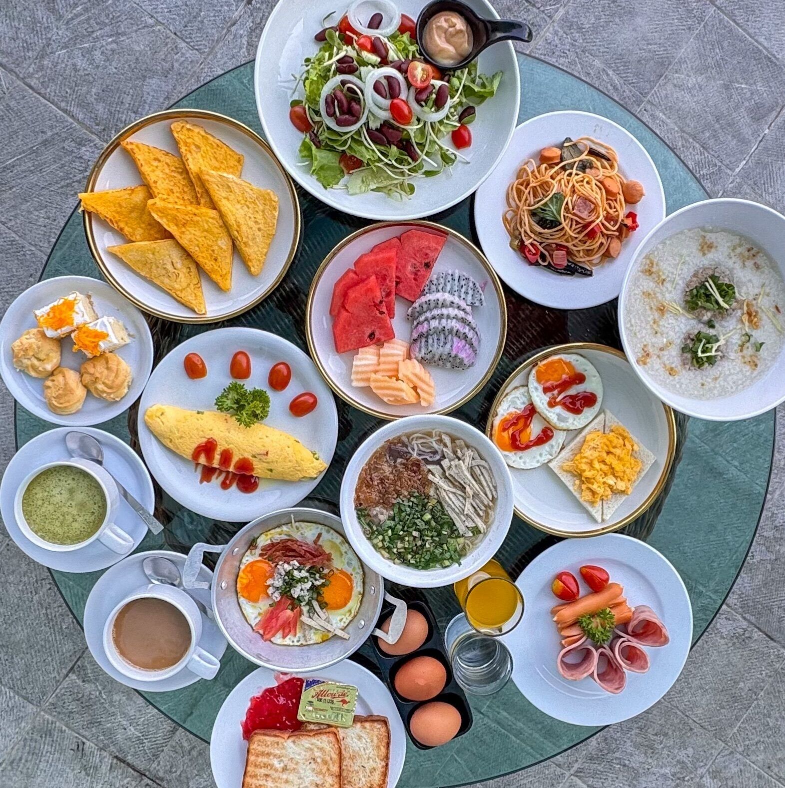 A variety of breakfast dishes arranged on a round table.