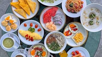 A variety of breakfast dishes arranged on a round table.