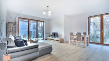 Deluxe Apartment, 1 Bedroom, Balcony | Living room | 40-inch flat-screen TV with cable channels, TV