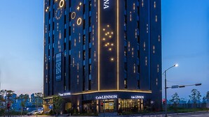 A modern hotel with a prominent sign reading "Hotel Lennon" and "Cafe Lennon" at the ground level. - Hotel Sienna (Paju)