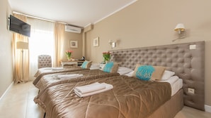A hotel room with a large bed, a desk, a chair, a flat-screen TV, and an air conditioning unit. - Riviera Airport Modlin (OLSZEWNICA NOWA)