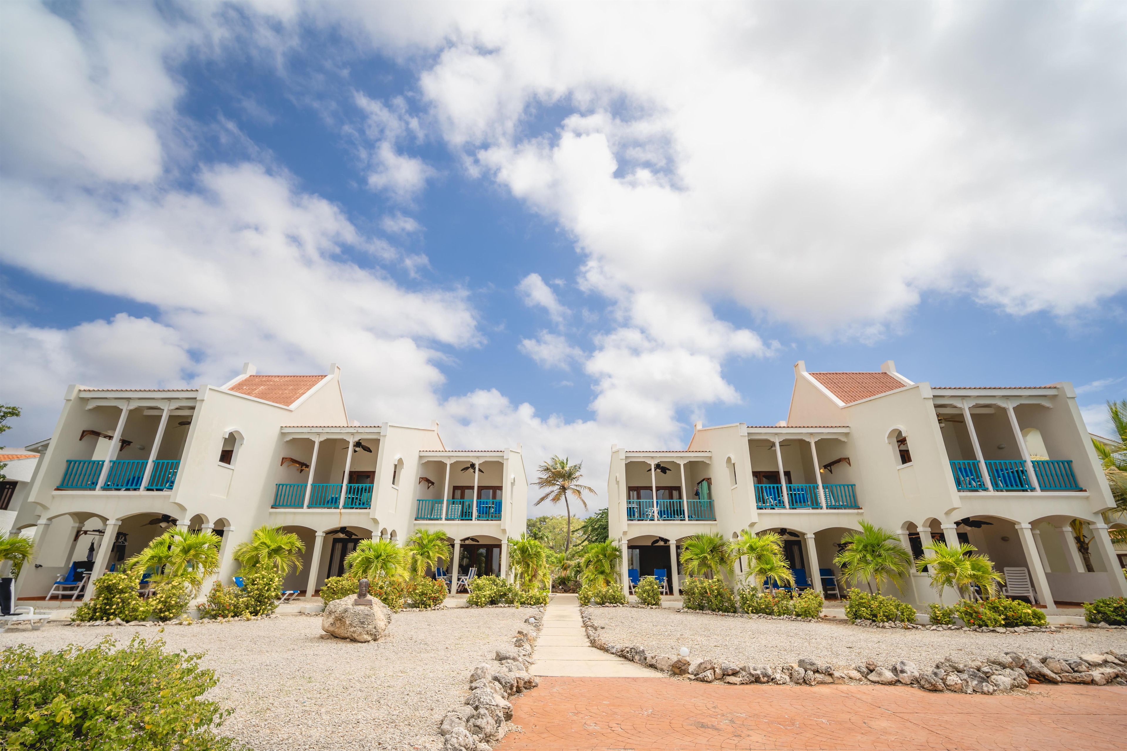A symmetrical building with multiple balconies and a central pathway.