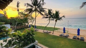 A pool area with a view of the beach and ocean during sunset. - Ubuntu Beach Villas By Reveal (Kamburugamuwa)
