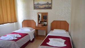 A hotel room with two single beds, a desk with a mirror, and a painting on the wall. - Hotel Ekol (Istanbul)