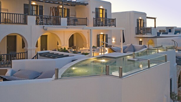A modern hotel with a rooftop pool, outdoor seating areas, and multiple balconies. - Parian Boutique Hotel (Paros)