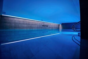 Indoor pool, open 9:00 AM to 9:00 PM, pool loungers, lifeguards on site