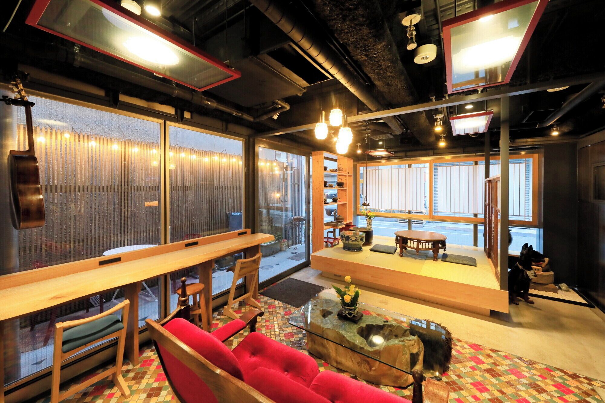 A modern interior with a seating area, a coffee table, and a view through large windows.