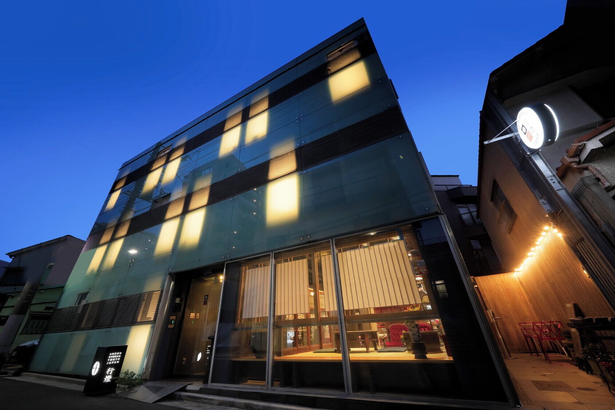 A modern building with large windows and a visible entrance.