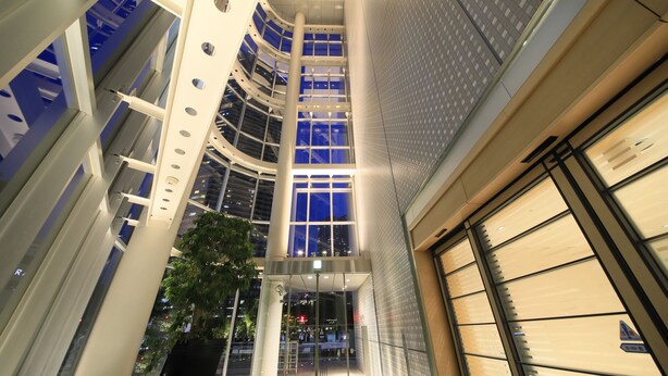 A modern building with a glass facade, a central atrium, and a large entrance with a glass door. - Richmond Hotel Premier Musashikosugi (Kawasaki)