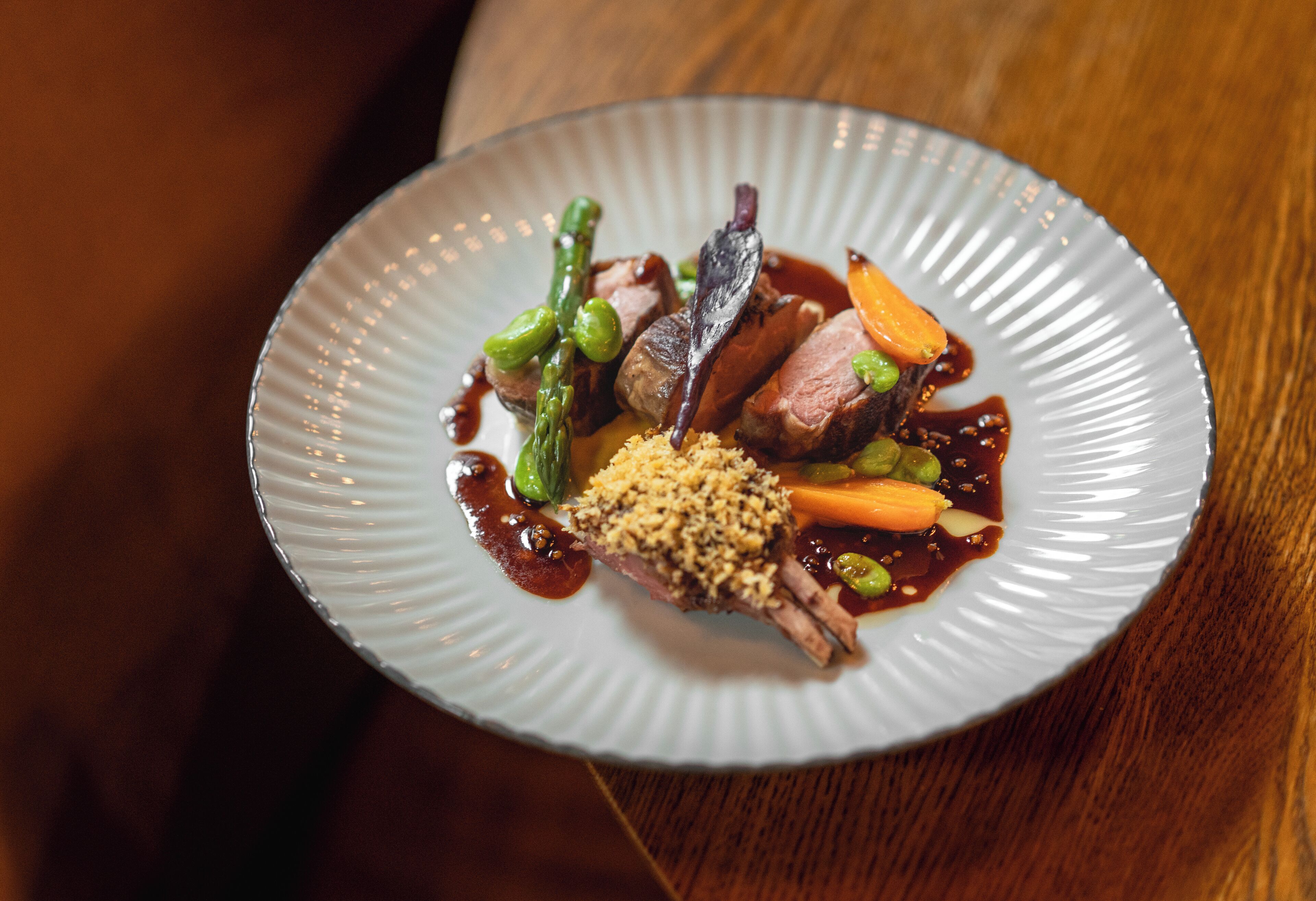 A plate of food with various vegetables and a piece of meat.