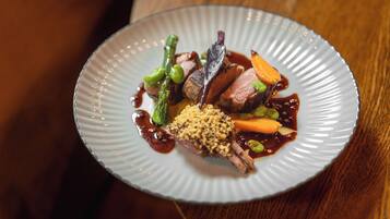 A plate of food with various vegetables and a piece of meat.