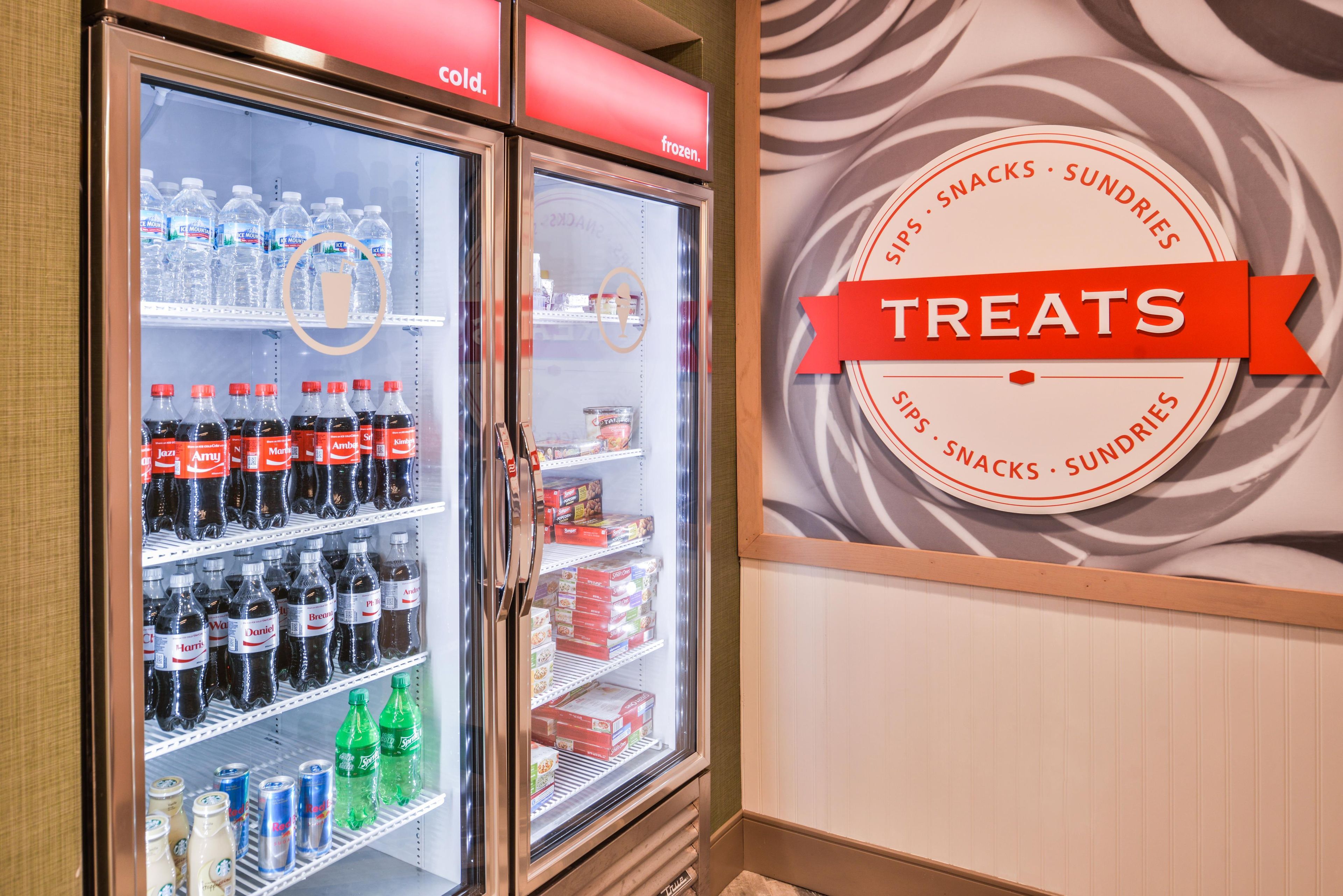 A refrigerated display case with beverages and snacks.
