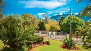 A well-maintained garden with various plants and a paved pathway. - Aan De Bergen Guesthouse South Africa (Swellendam)