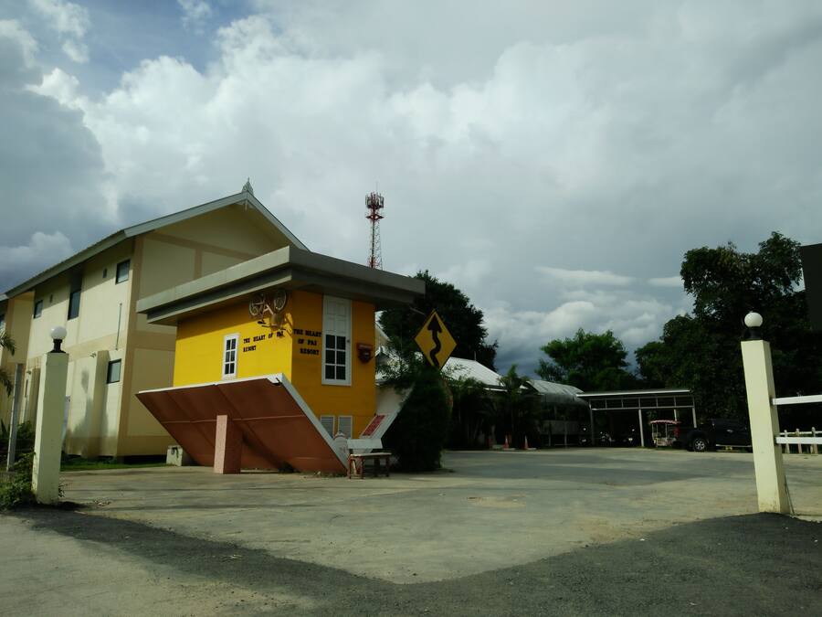 A yellow building with a sign reading "The Heart of Pai Resort".