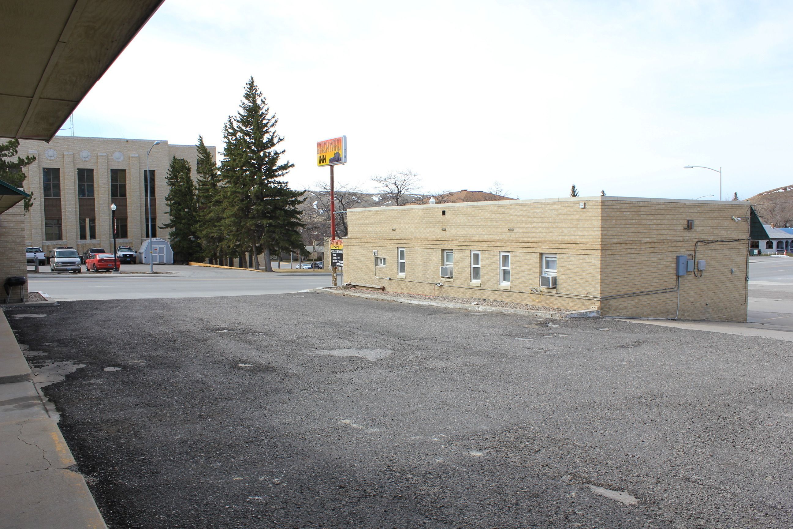 A parking lot with a building in the background.