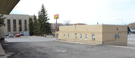 A parking lot with a building in the background.