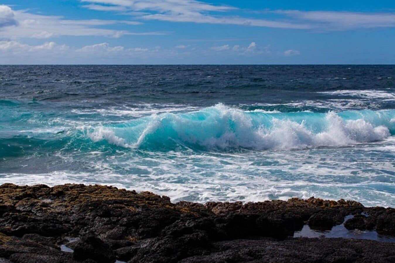 A rocky coastline with waves crashing against the rocks.