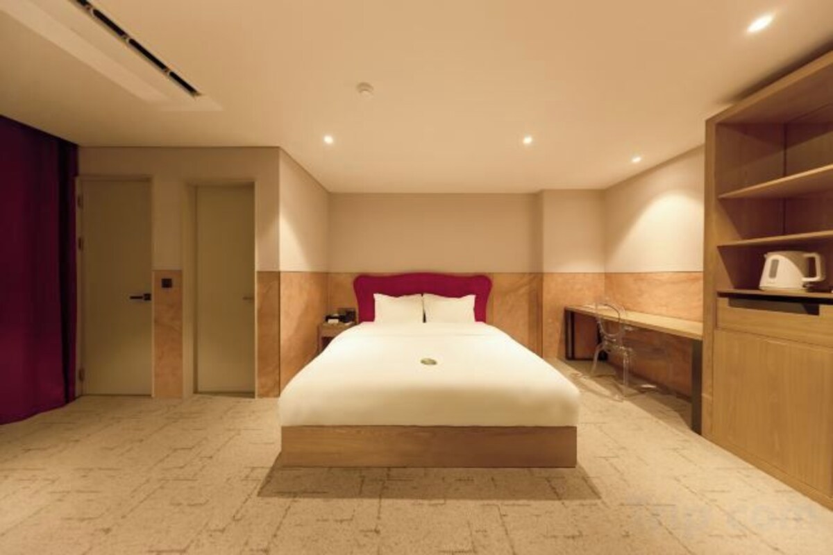 Premium bedding, desk, laptop workspace, blackout drapes