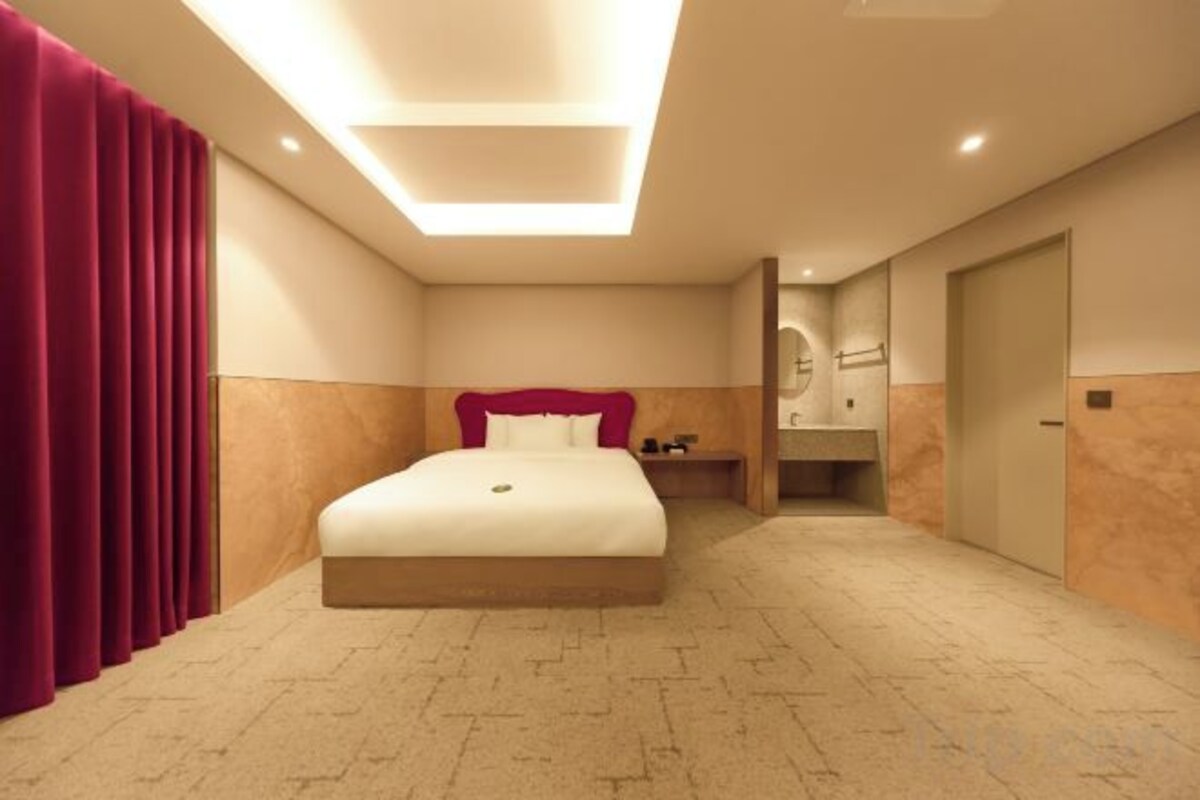 Premium bedding, desk, laptop workspace, blackout drapes