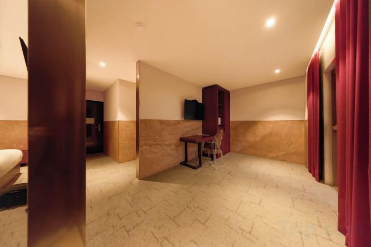 Premium bedding, desk, laptop workspace, blackout drapes