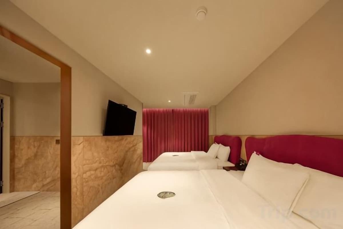 Premium bedding, desk, laptop workspace, blackout drapes