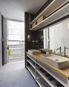 A modern bathroom with two sinks, a large mirror, and a window. - On the bed Hostel (Bangkok)
