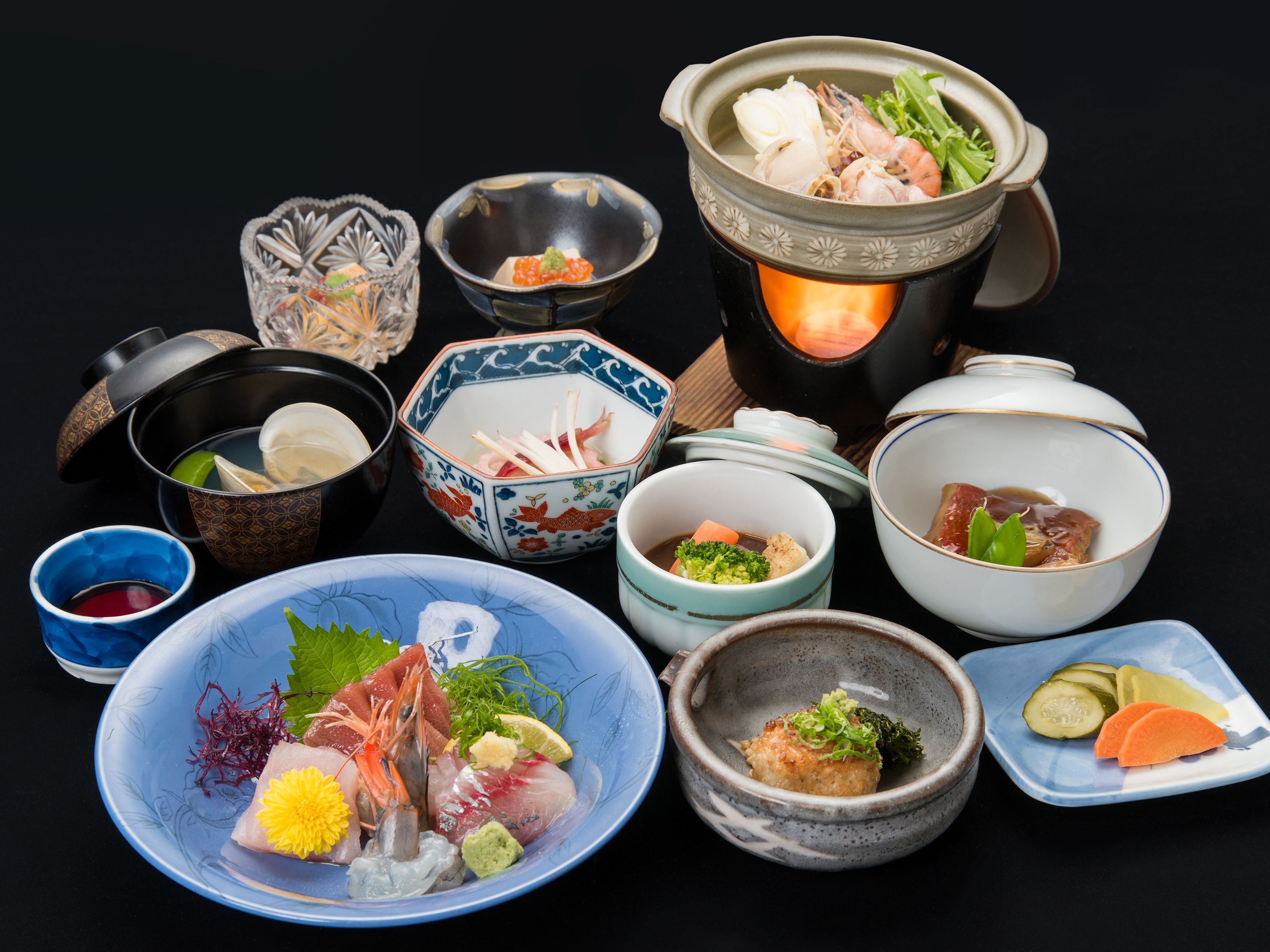 A variety of Japanese dishes and bowls on a table.