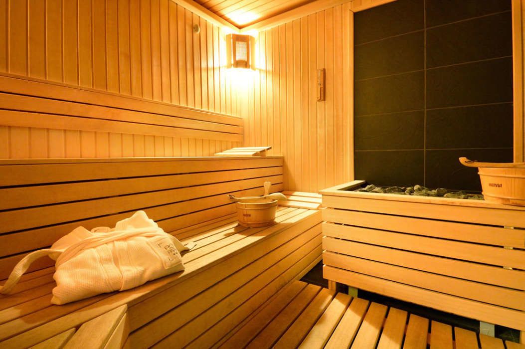 A wooden sauna with benches and a bench with a towel.