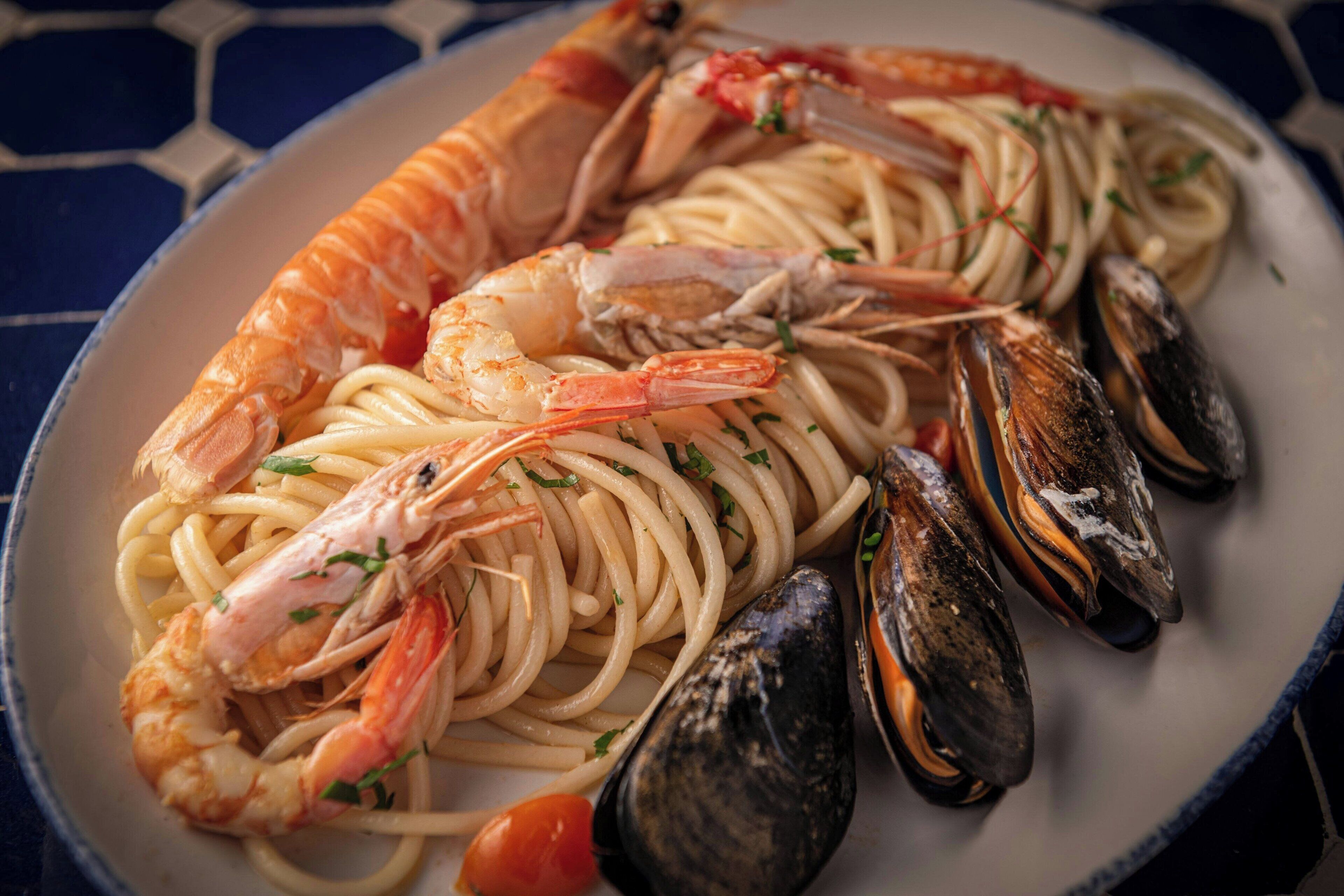 A plate of spaghetti with shrimp and mussels.