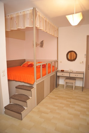 A compact room with a bunk bed, a desk with a chair, and a small stool. - Takis Hotel (Rhodes)