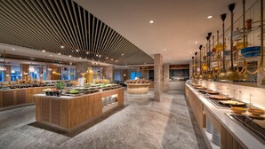 A modern buffet area with marble flooring, wooden counters, and a variety of food options. - Trendy Palm Beach (Adults Only, 16+) - All inclusive (Manavgat)