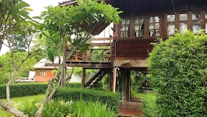 A wooden house with a balcony and a staircase leading to an upper level. - Vimarnkiri Resort (Pai)