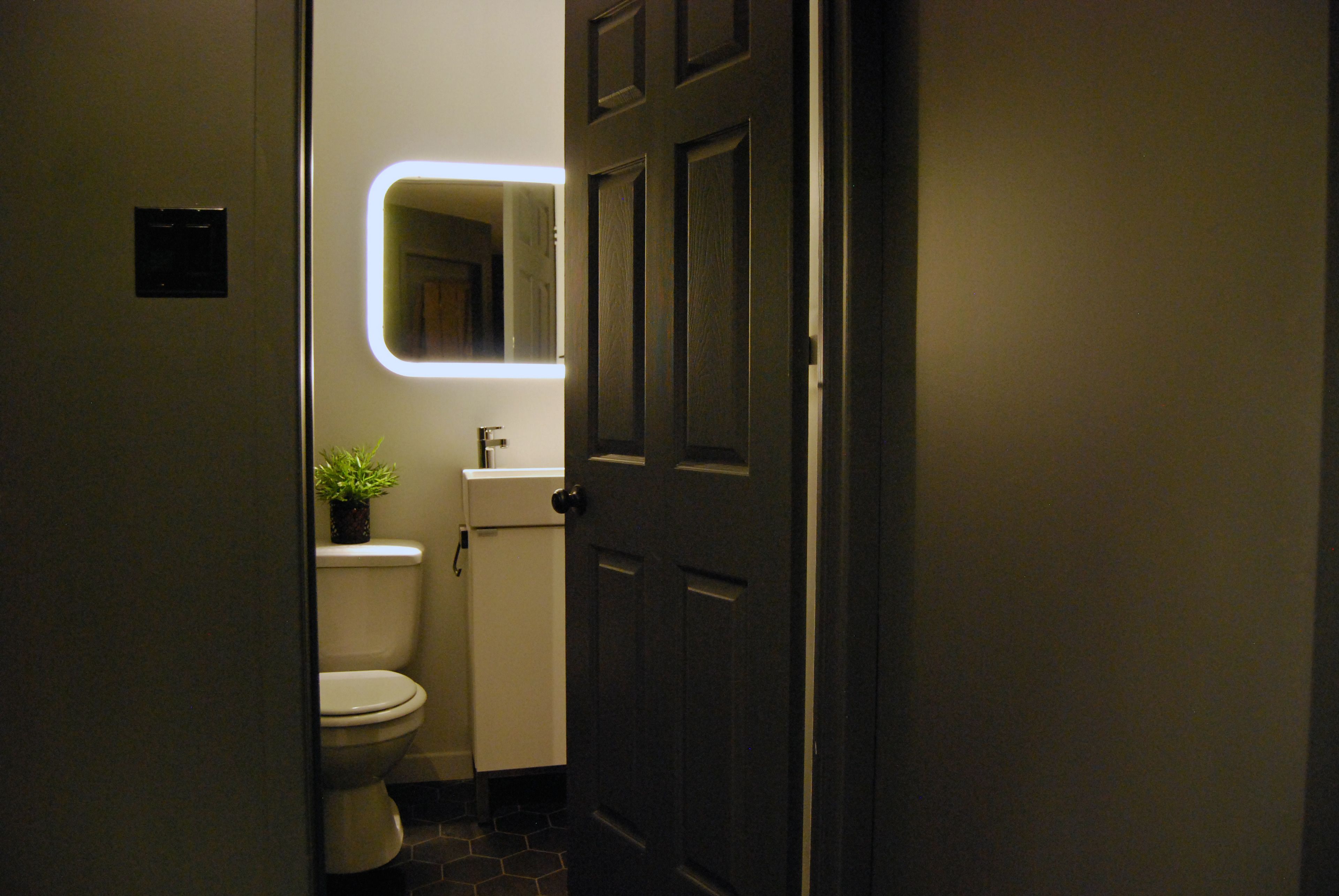 Ein Badezimmer mit Toilette, Waschbecken und Spiegel.