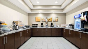 A modern kitchen with granite countertops, stainless steel appliances, and a central island. - Comfort Suites Rensselaer near Fair Oaks (Rensselaer)