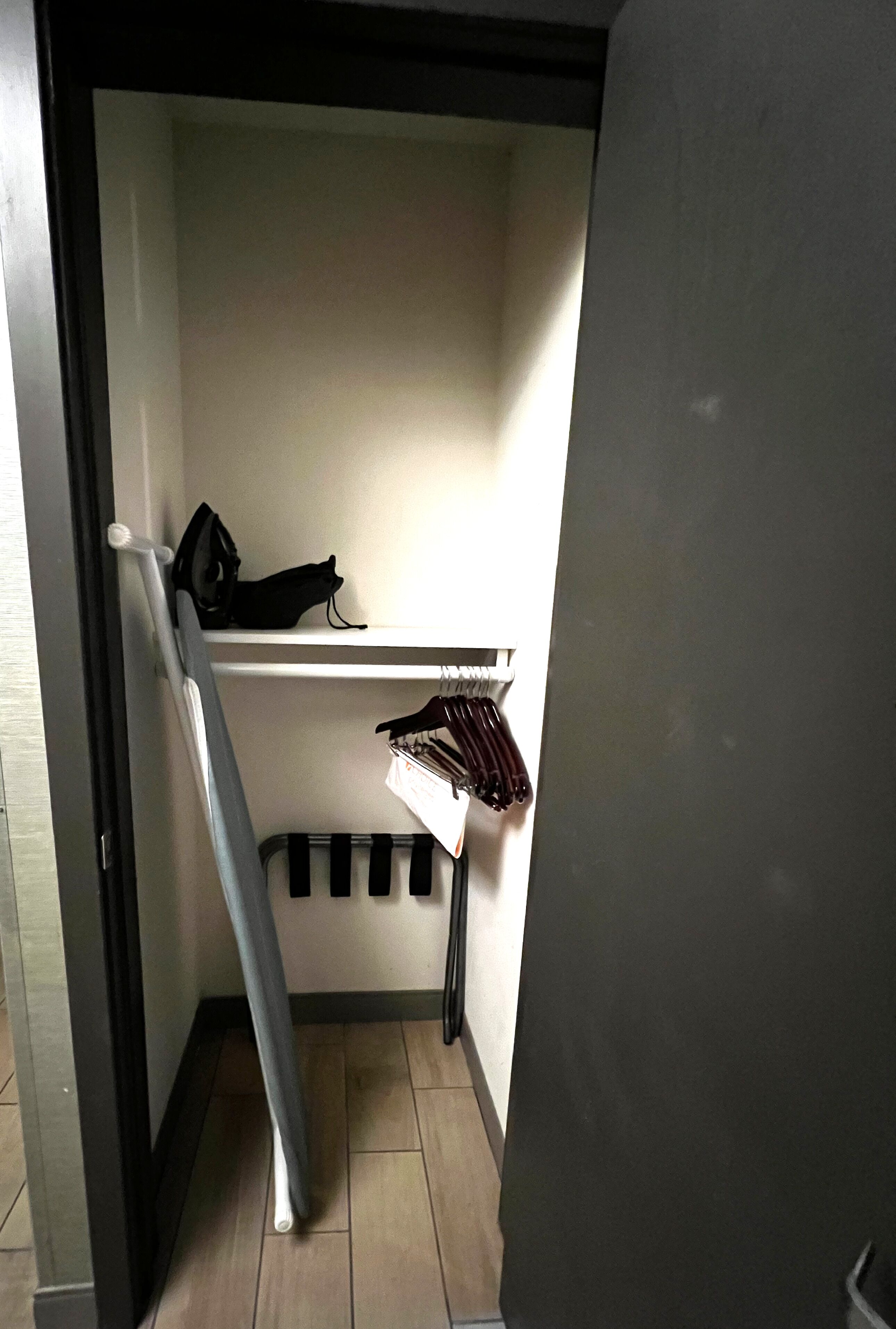 A compact room with a built-in bench and a small shelf.