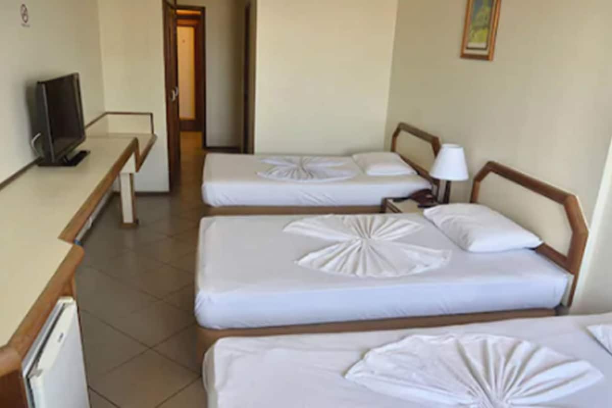 standard triple room, 3 single beds, non smoking, bay view | minibar, desk, blackout curtains, cots/infant beds