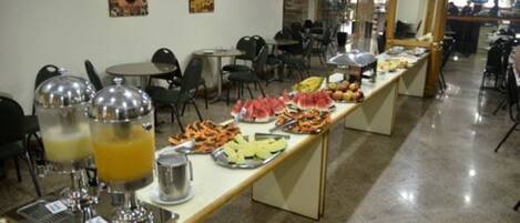 A buffet setup with various food items and drinks.