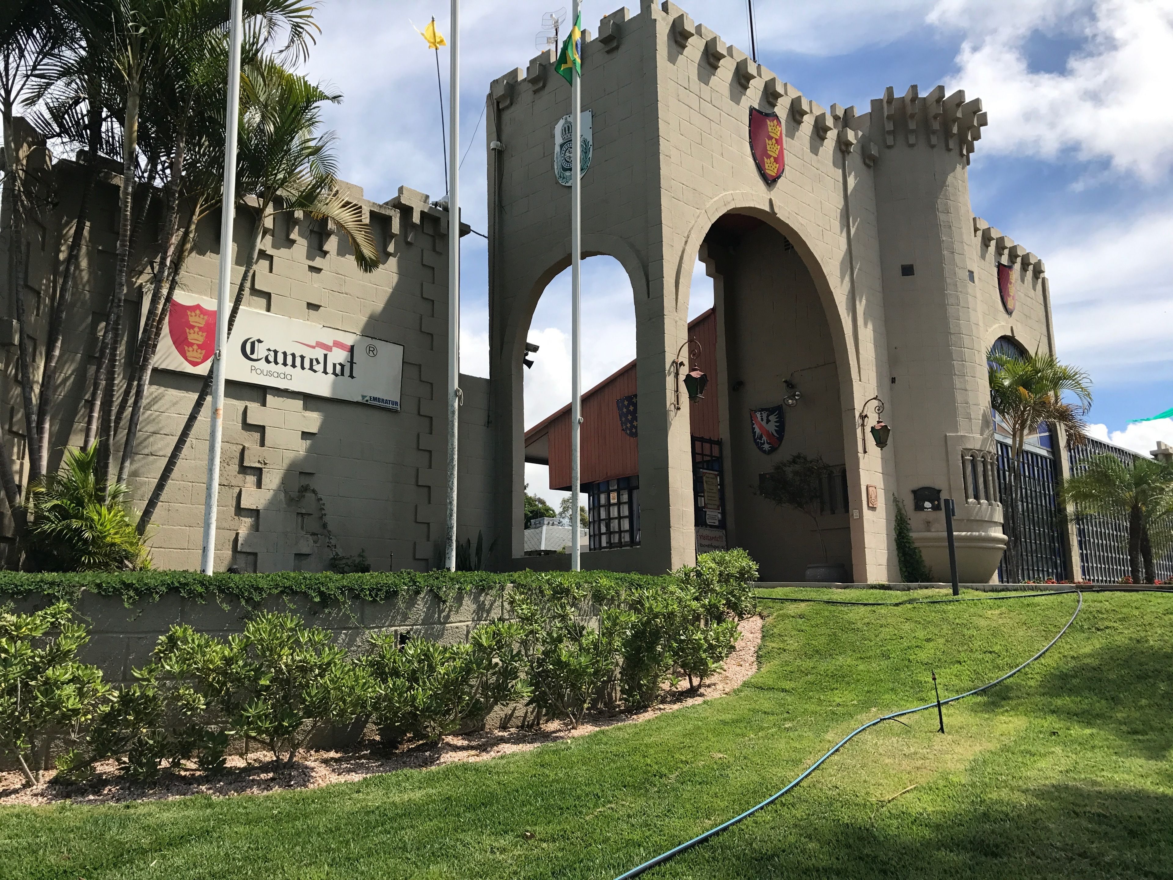 A castle-like structure with a sign reading "Camelot Pousada".