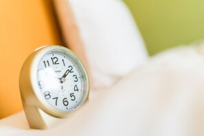 A TAG clock on a bedside table.