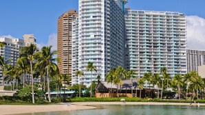 A large hotel with multiple high-rise buildings, palm trees, and a beachfront. - Marina Hawaii Vacations at the Ilikai Tower (Honolulu)