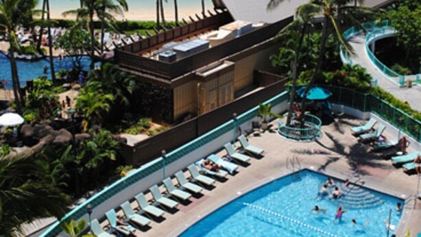 A resort with a large pool, a beach, and palm trees. - Marina Hawaii Vacations at the Ilikai Tower (Honolulu)