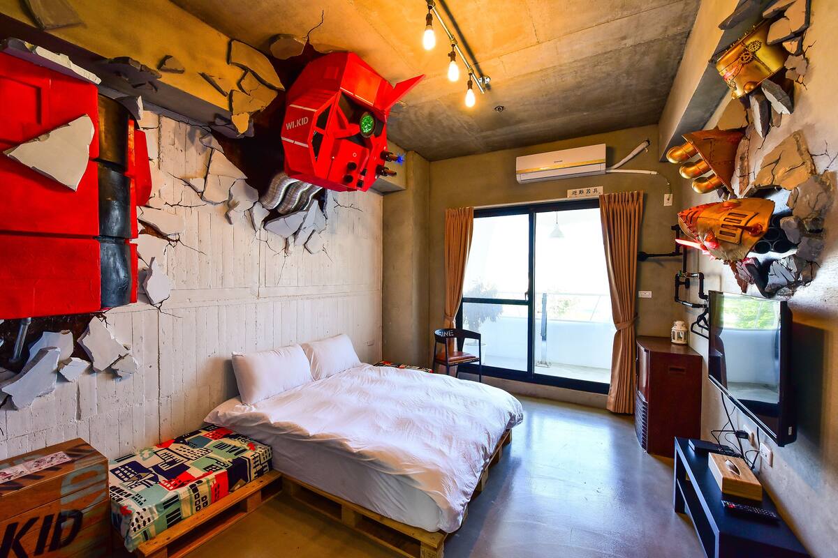 A room with a bed, a wooden bench, a TV, and a window with curtains.