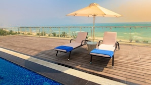On the beach, white sand, beach towels - Serene Beach Hotel Danang (Da Nang)