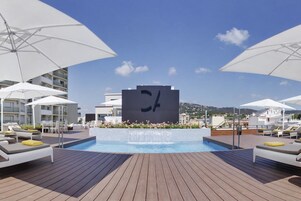 Piscine extérieure en saison, parasols, chaises longues